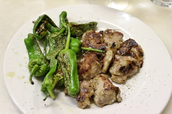 A plate of shishito peppers and grilled pork