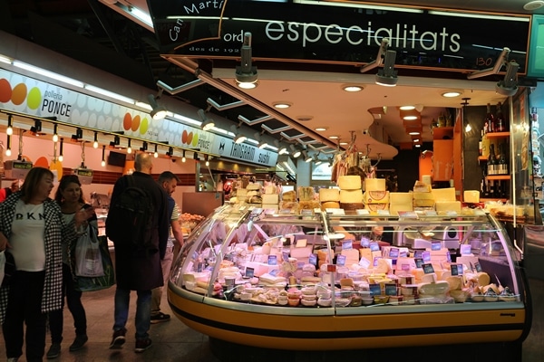 people walking around a large food market