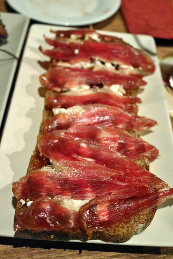 closeup of an open-face sandwich topped with Spanish ham