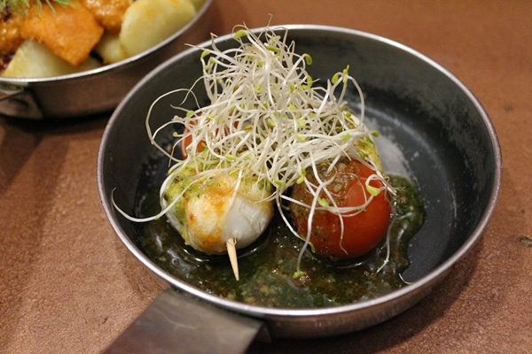 a dish of cherry tomatoes and mozzarella