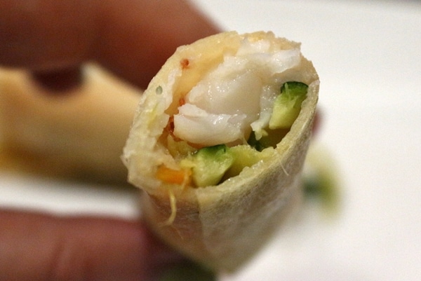 A close up of a half-eaten spring roll