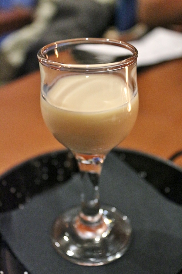 A shot glass of a creamy drink