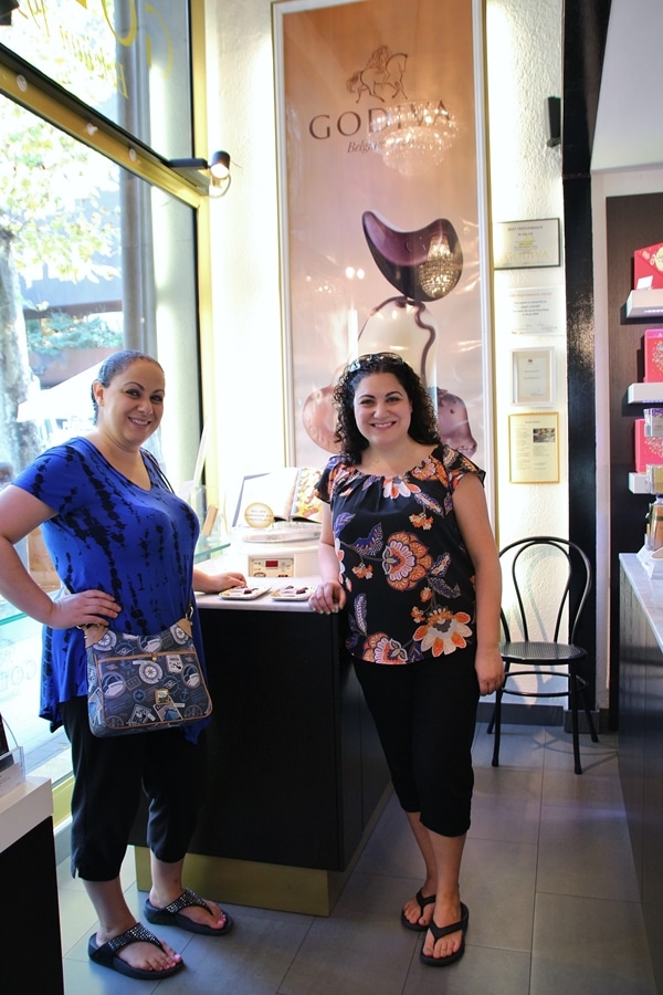 2 women standing in a chocolate shop