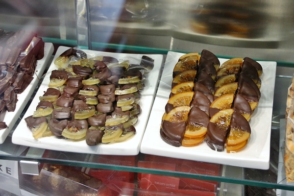 chocolate covered citrus slices in a display case