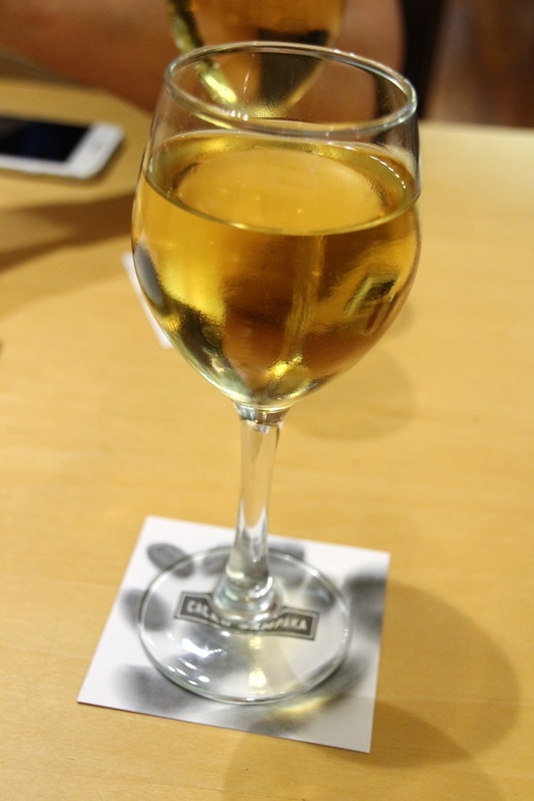 A glass of wine sitting on top of a wooden table