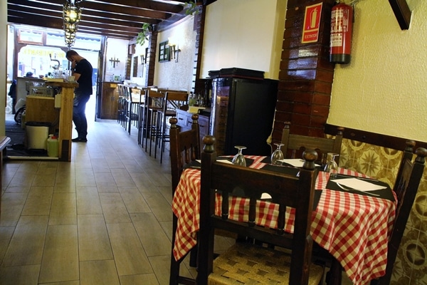 interior of a cozy restaurant dining room with checkered tablecloths