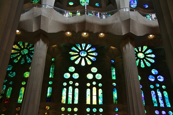 green and blue stained glass windows inside a church