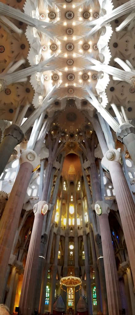 the altar and tall ceilings inside Sagrada Familia