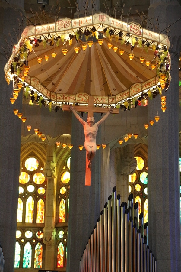 a crucifix hanging over the altar in a church