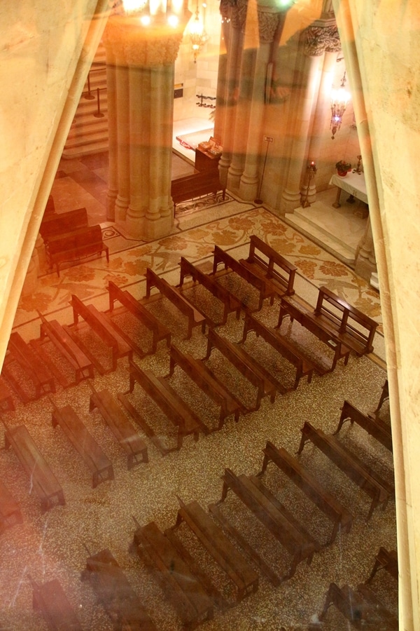 A row of wooden benches in a small chapel