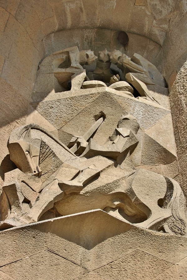 view looking up at cubist statues on exterior of Sagrada Familia