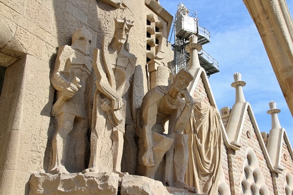 several stone cubist statues outside Sagrada Familia