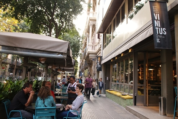 A group of people dining at a sidewalk cafe