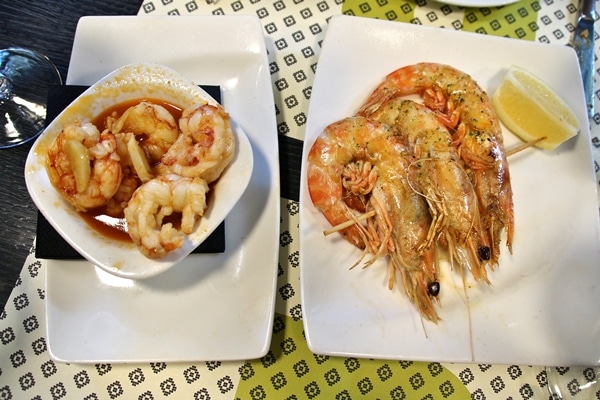 overhead view of a bowl of shrimp and a plate of langoustines