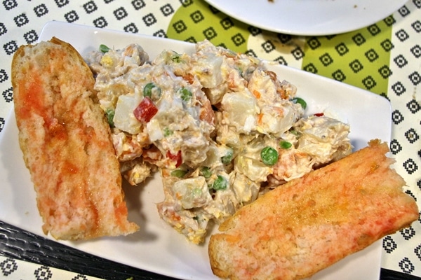 a plate of potato salad served with tomato-rubbed bread