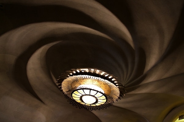 a light on a ceiling that has a spiral design