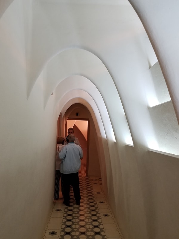 a white hallway with tall arches