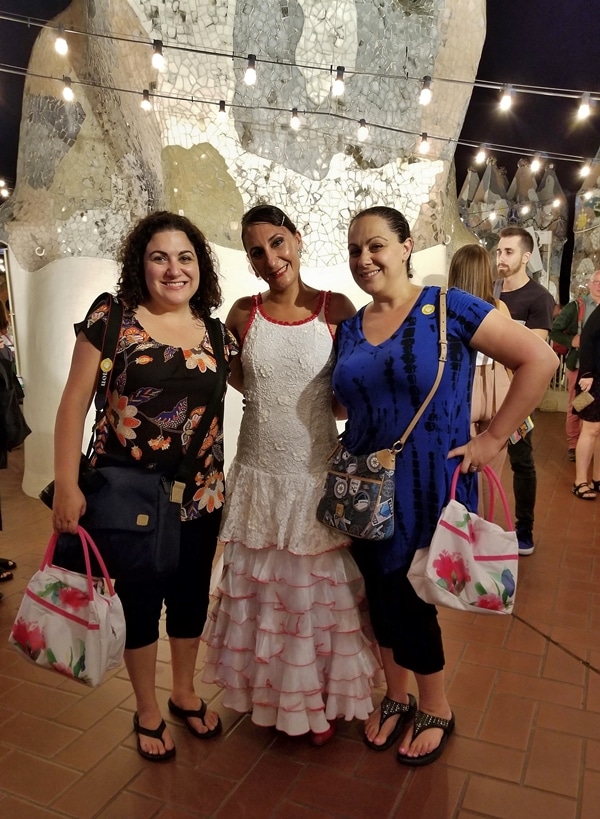 3 women posing outdoors at night