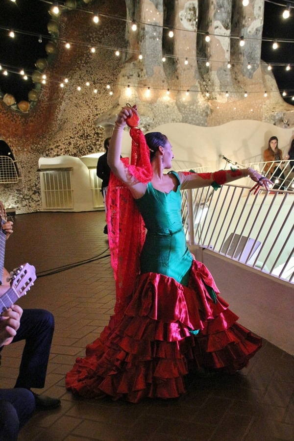 a flamenco dancer wearing a green and red dress