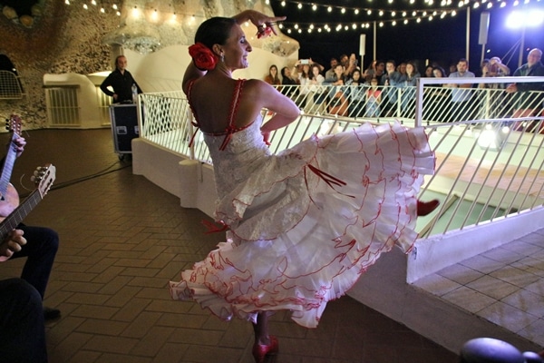 a female dancer wearing white, kicking in the air