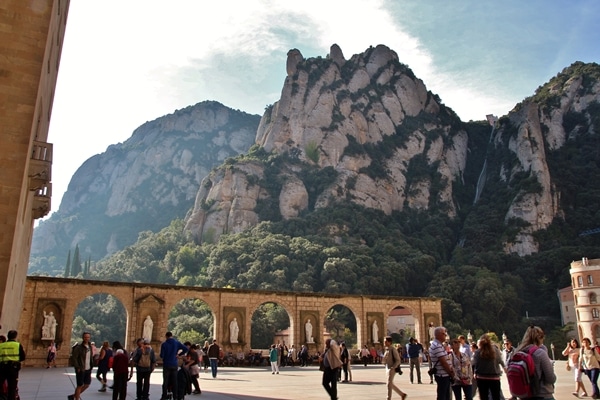 A group of people walking in front of a mountain