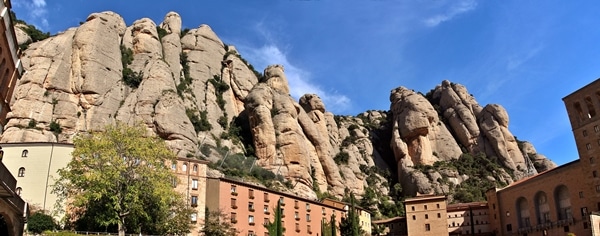 Montserrat with buildings in front of the jagged mountains