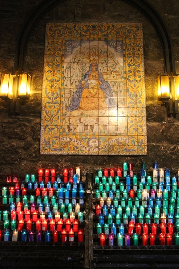 colorful candles burning near a church