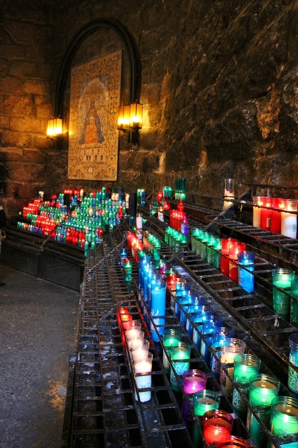 colorful candles lit in prayer