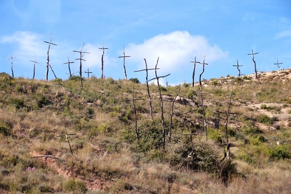 crosses made out of big sticks in a field
