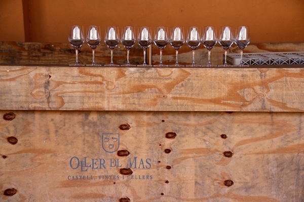 A wooden box topped with wine glasses