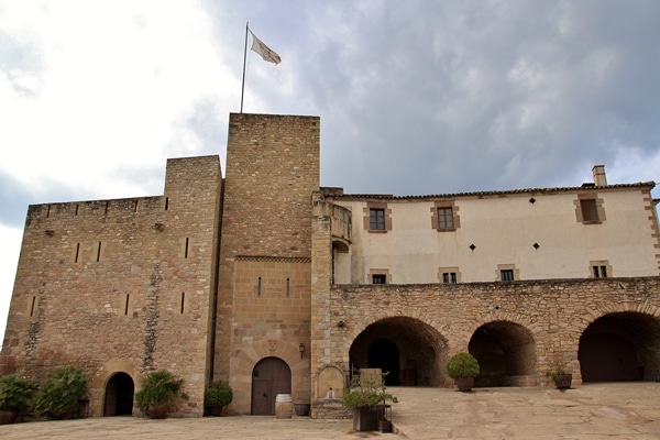 A large stone building with a flag on top