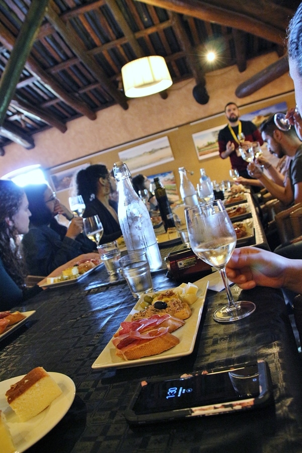 people dining on tapas at a long table