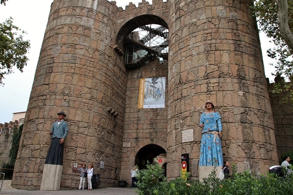 a stone building with statues of people in front of it