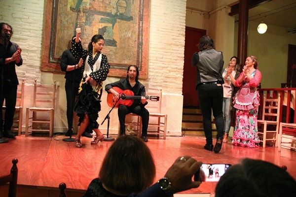 a group of flamenco dancers on a stage