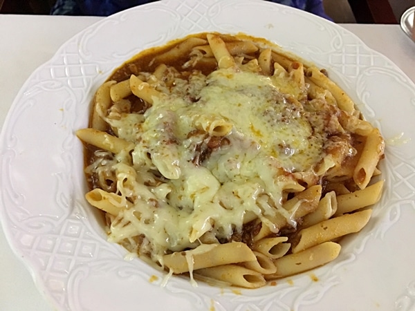 A dish is of pasta covered with melted cheese