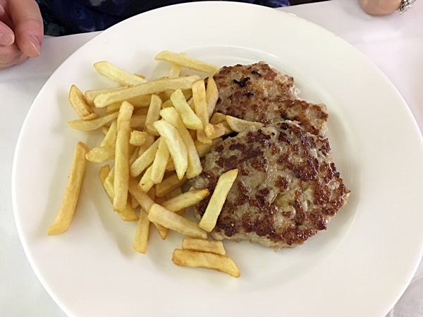 a plate of meat patties with french fries