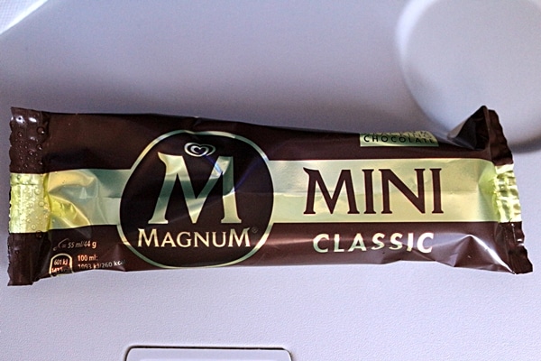 a wrapped ice cream bar on an airplane tray table