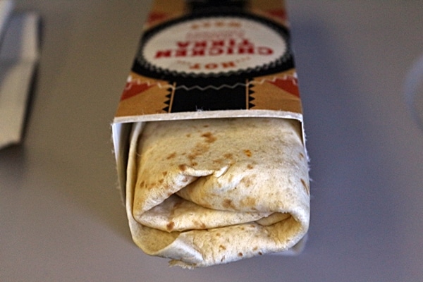 a Chicken Tikka Wrap extending out of its box