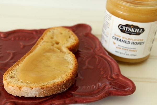 A close up of creamed honey spread on a piece of toast