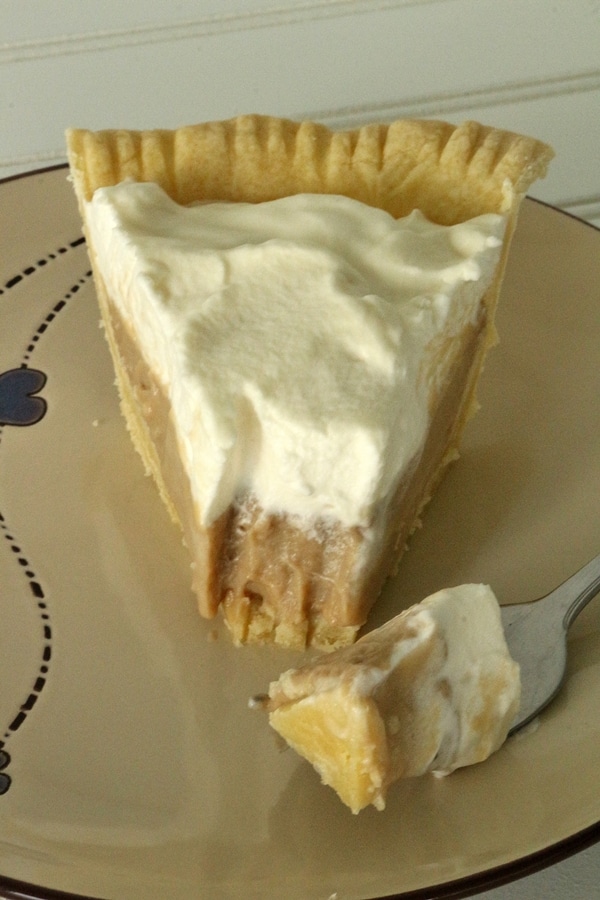 a slice of cream pie with a bite on a fork