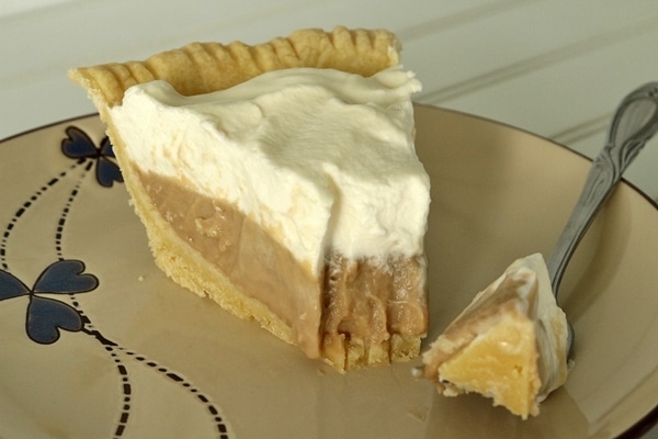 a slice of cream pie with a bite removed