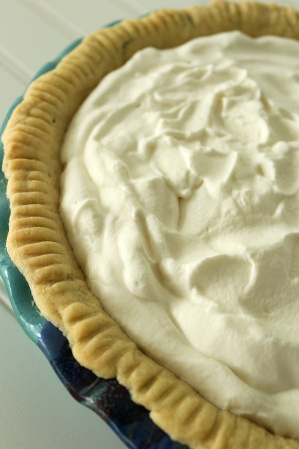 a cream pie in a blue pie dish