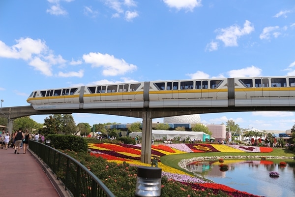 a monorail crossing over a pond at Epcot