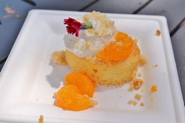 a piece of cake with oranges and cream