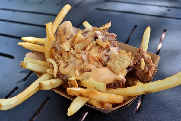 a plate of poutine french fries with cheese sauce and braised meat