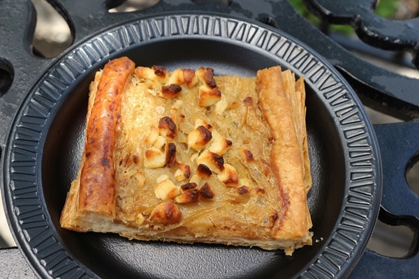 a piece of onion and goat cheese tart on a plate plate