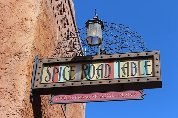 A sign on the side of a building that says Spice Road Table