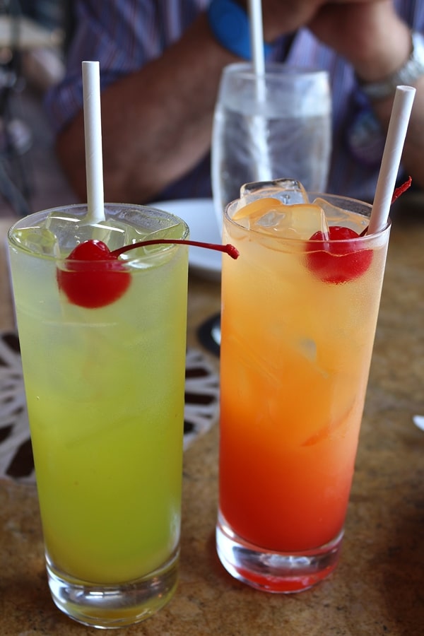 2 colorful cocktails in tall glasses