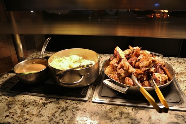 several pans of food on a buffet