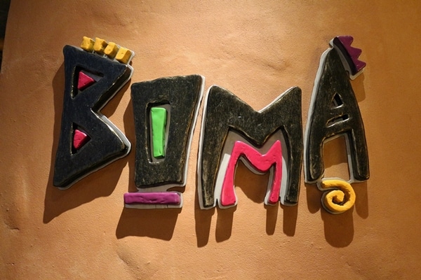 a colorful wall sign that says Boma